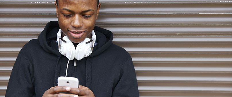 teenage boy with headphones around neck